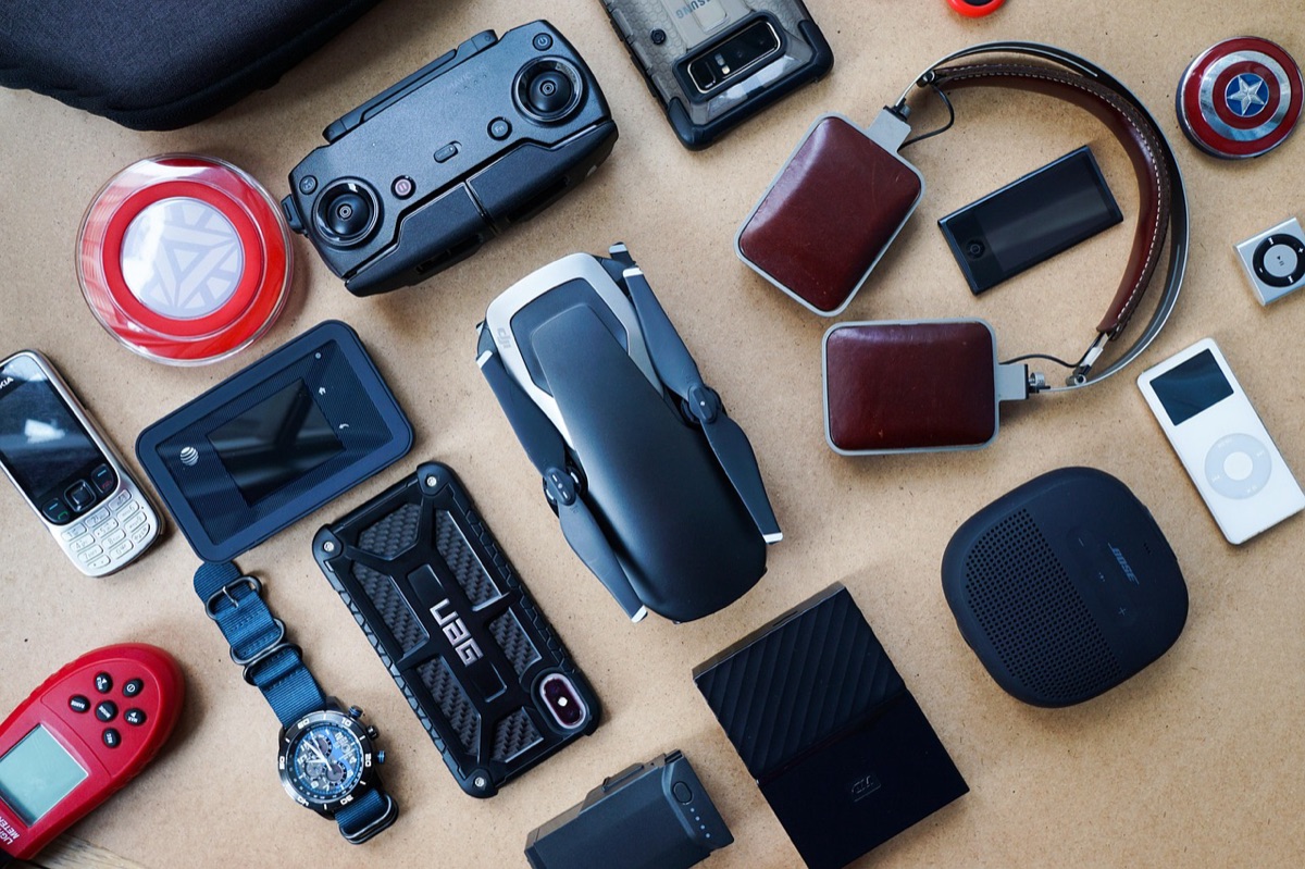 Modern high-tech gadgets including wireless headphones and a smartwatch