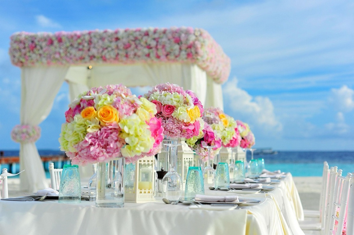 Rustic wedding table setup with red wine, bread, and fruit